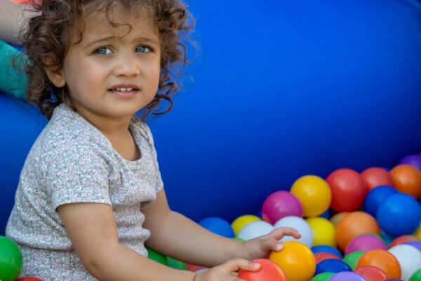 SWS child playing in bounce house ball pit